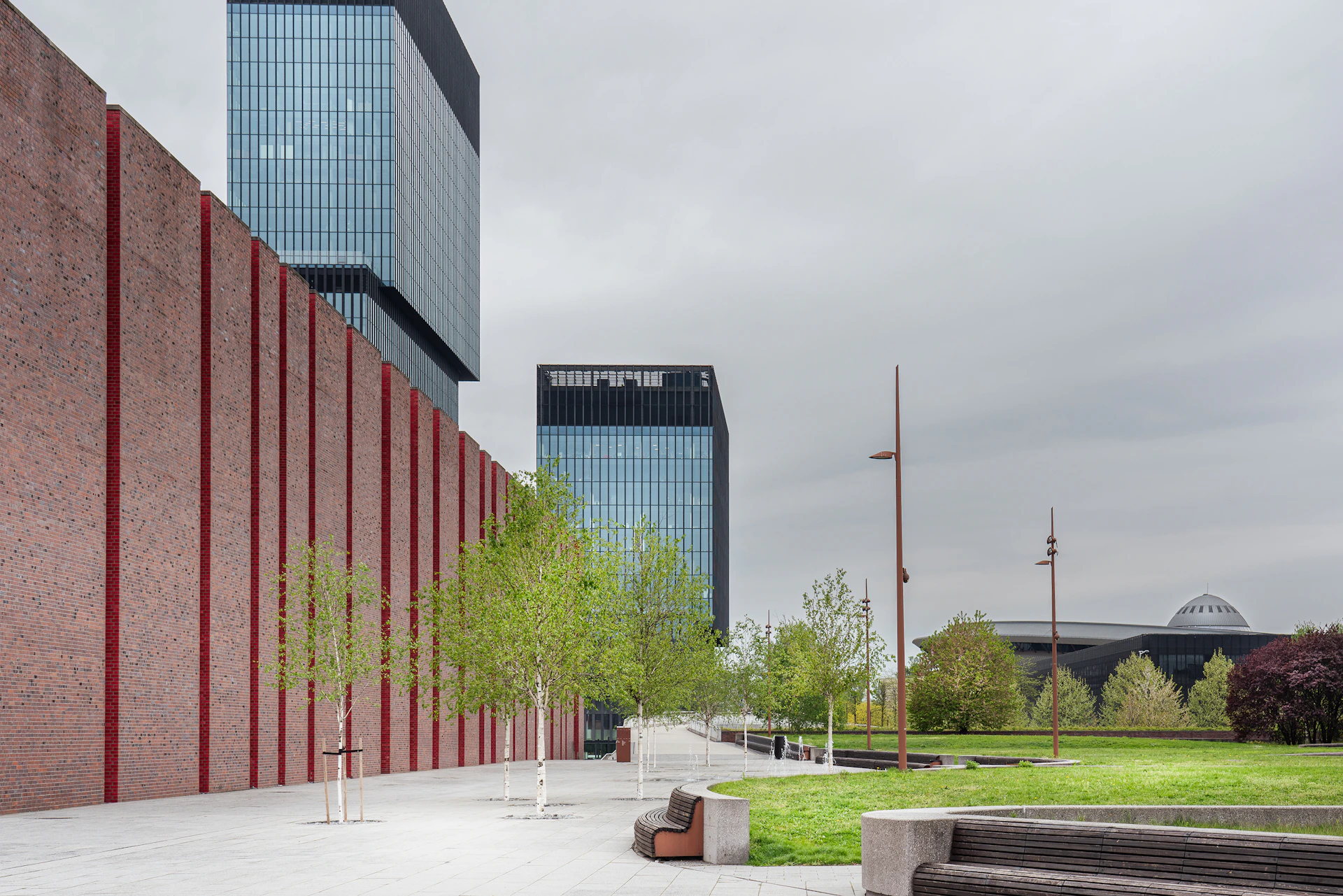 a bench sitting in front of a tall building