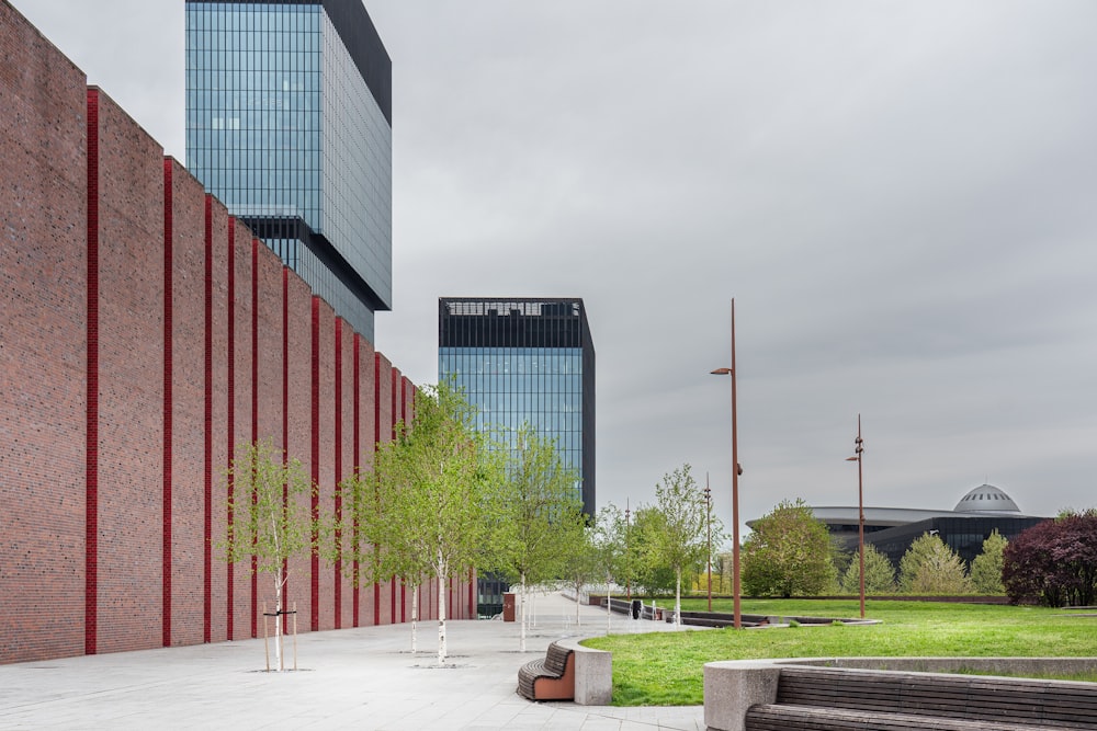 a bench sitting in front of a tall building