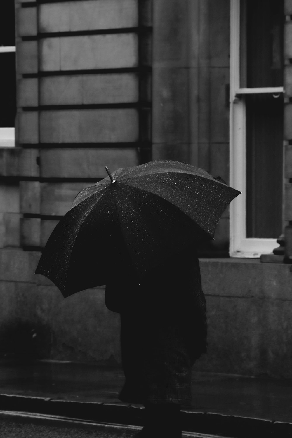 a person walking down a street holding an umbrella