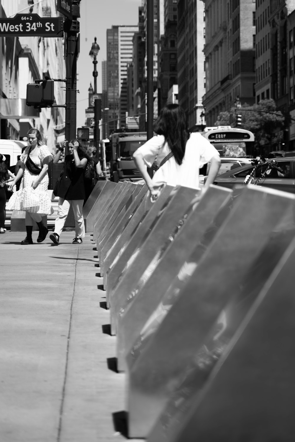 a black and white photo of a person sitting on a bench