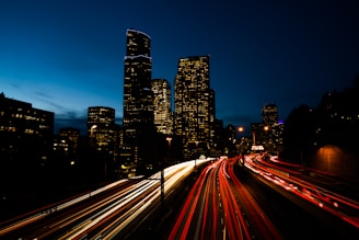 a view of a city at night from a bridge