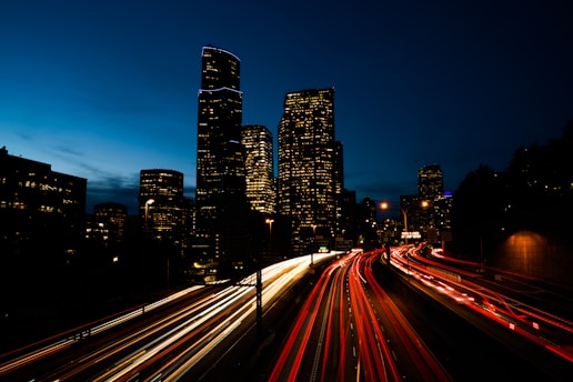 a view of a city at night from a bridge