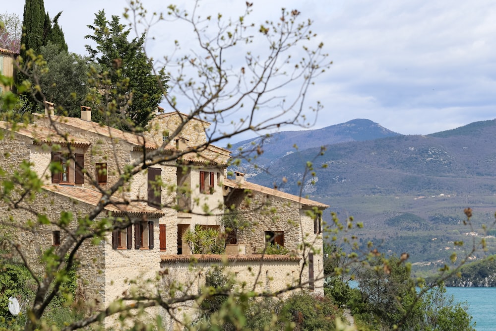 a house with a view of a lake and mountains in the background