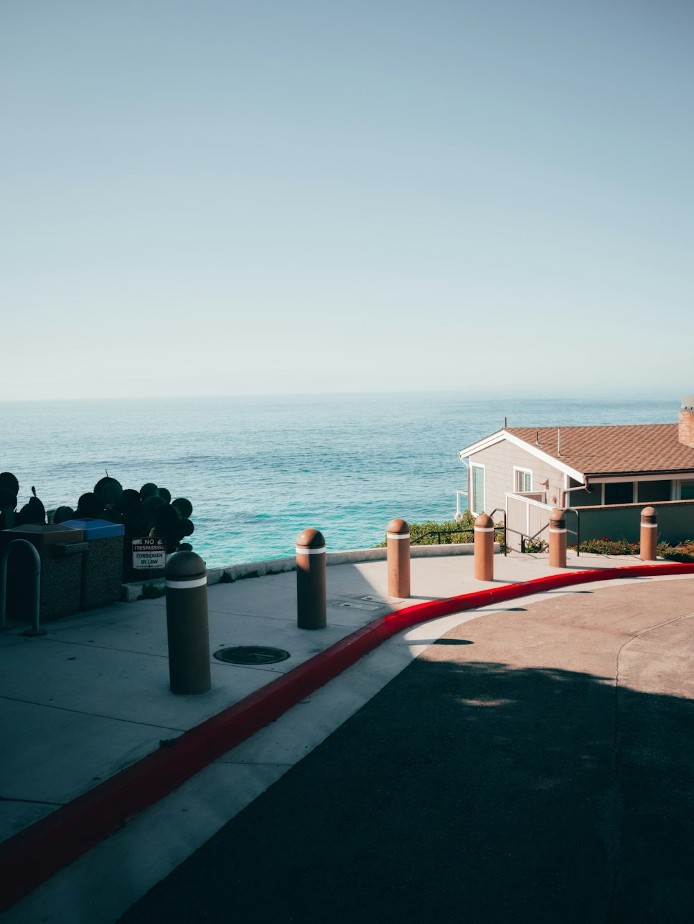 a fire hydrant on the side of a road near the ocean