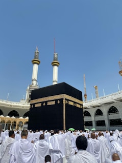 a group of men standing in front of a large building