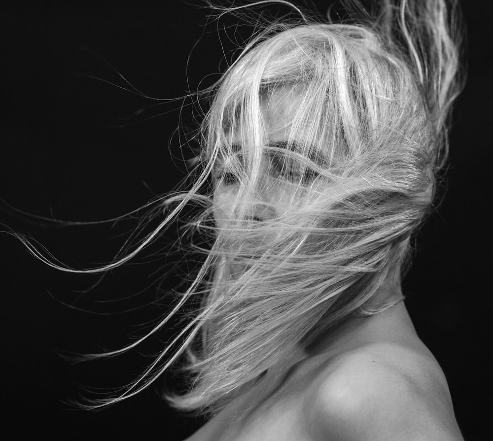 a woman with her hair blowing in the wind