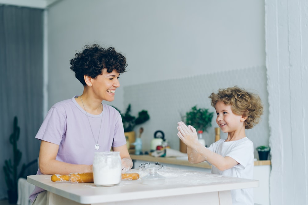 a woman and a child are sitting at a table