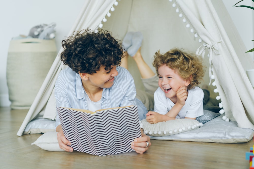 a woman reading a book to a child