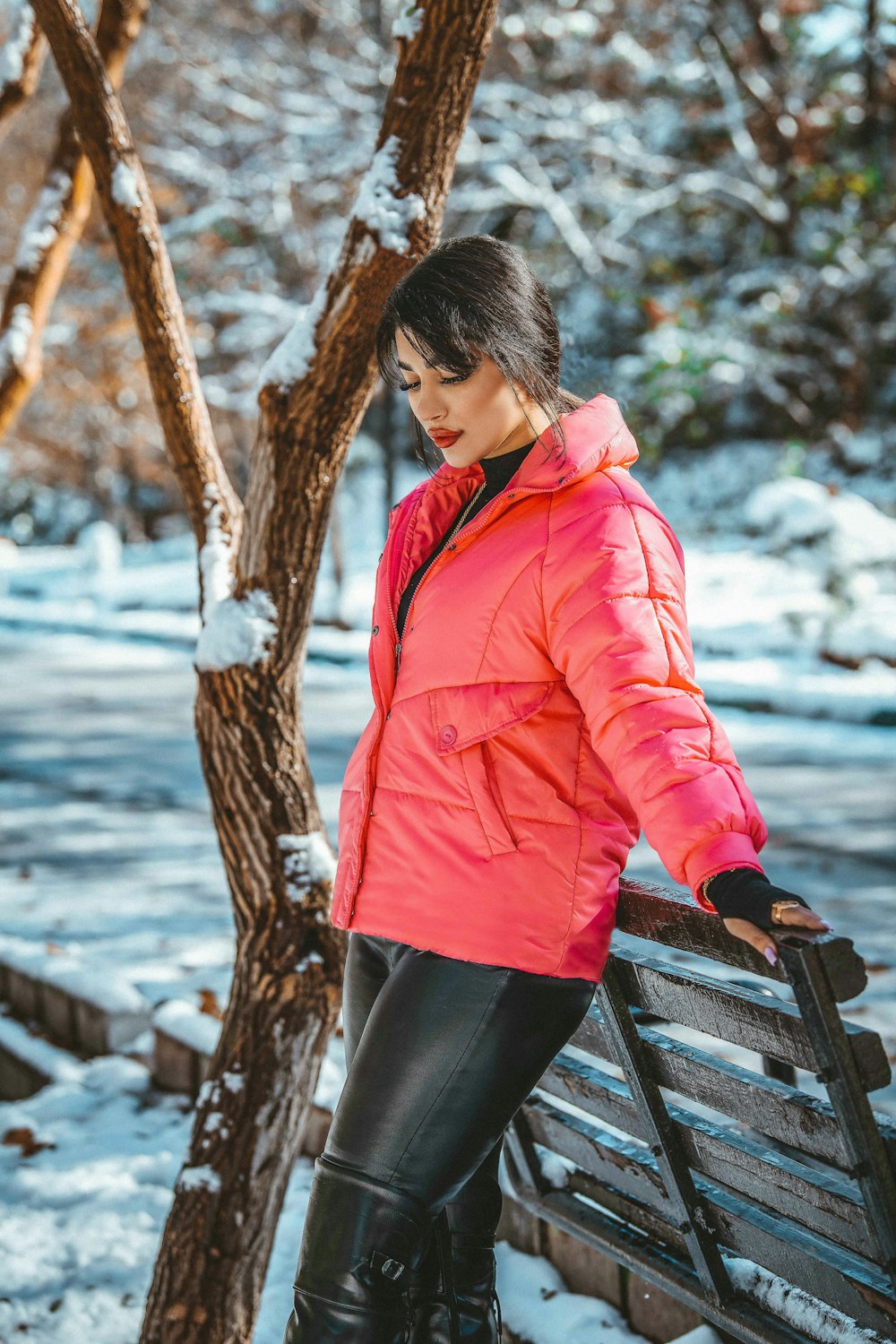 a woman standing on a bench in the snow