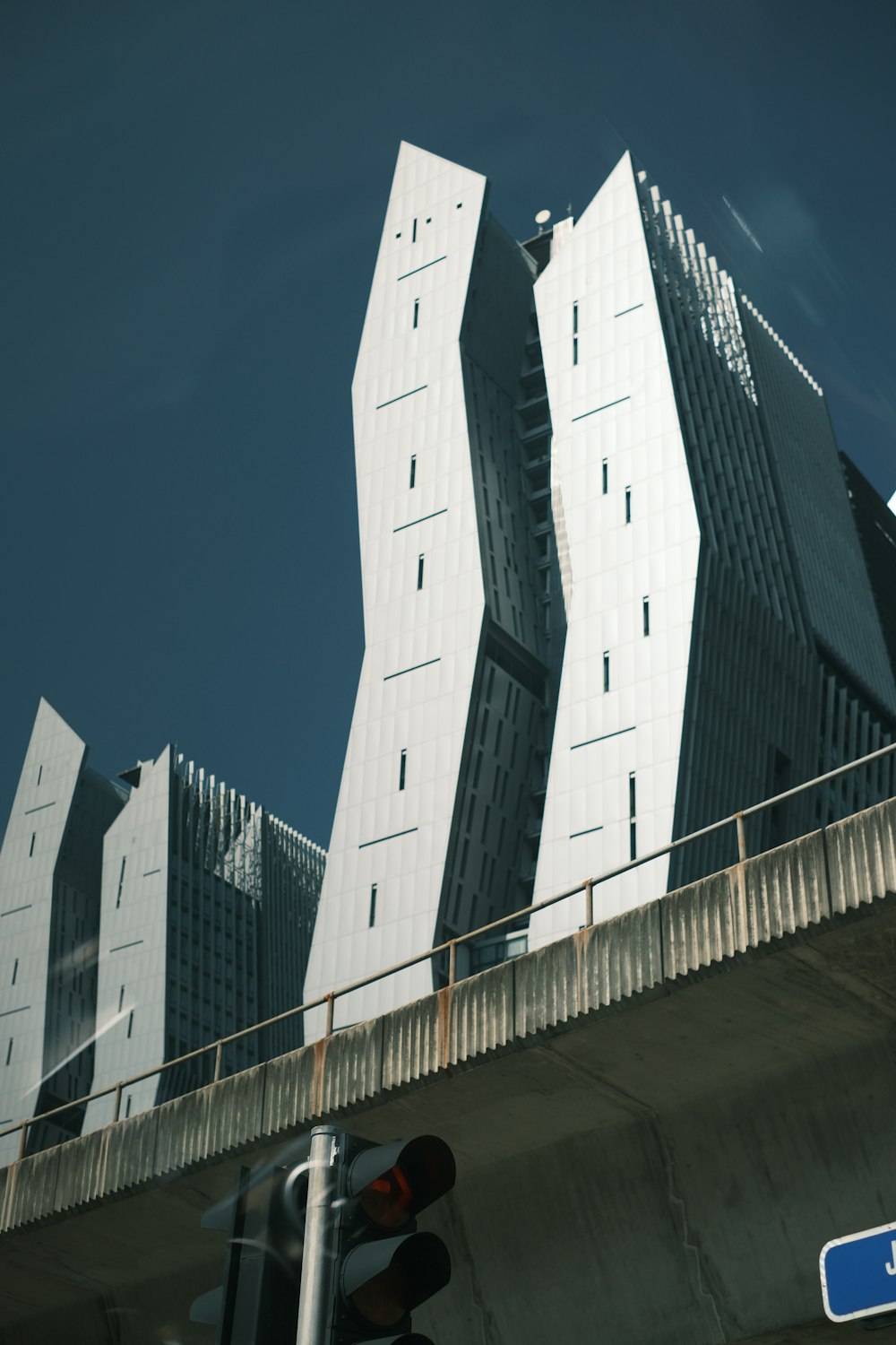 a traffic light sitting below a tall building