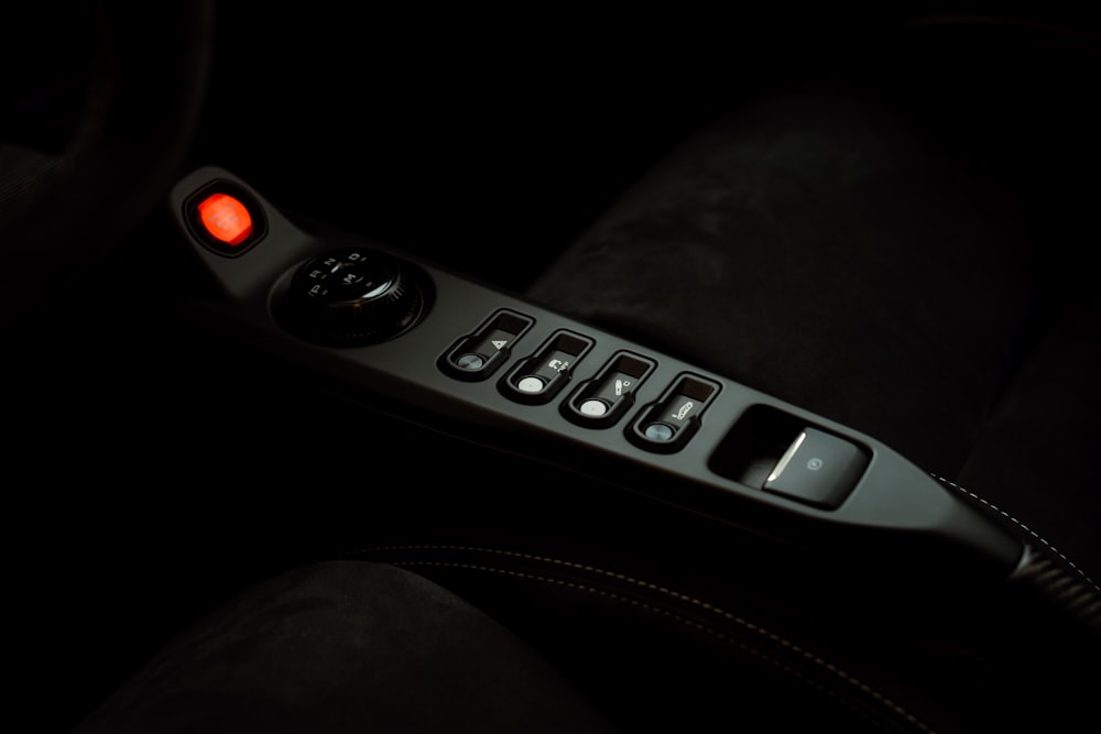 a close up of a remote control in the dark