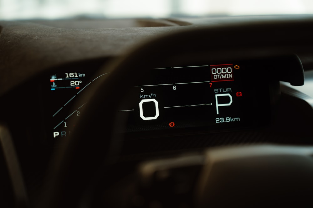 a close up of a car dashboard with a speedometer