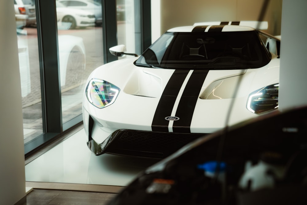 a white sports car parked in a showroom