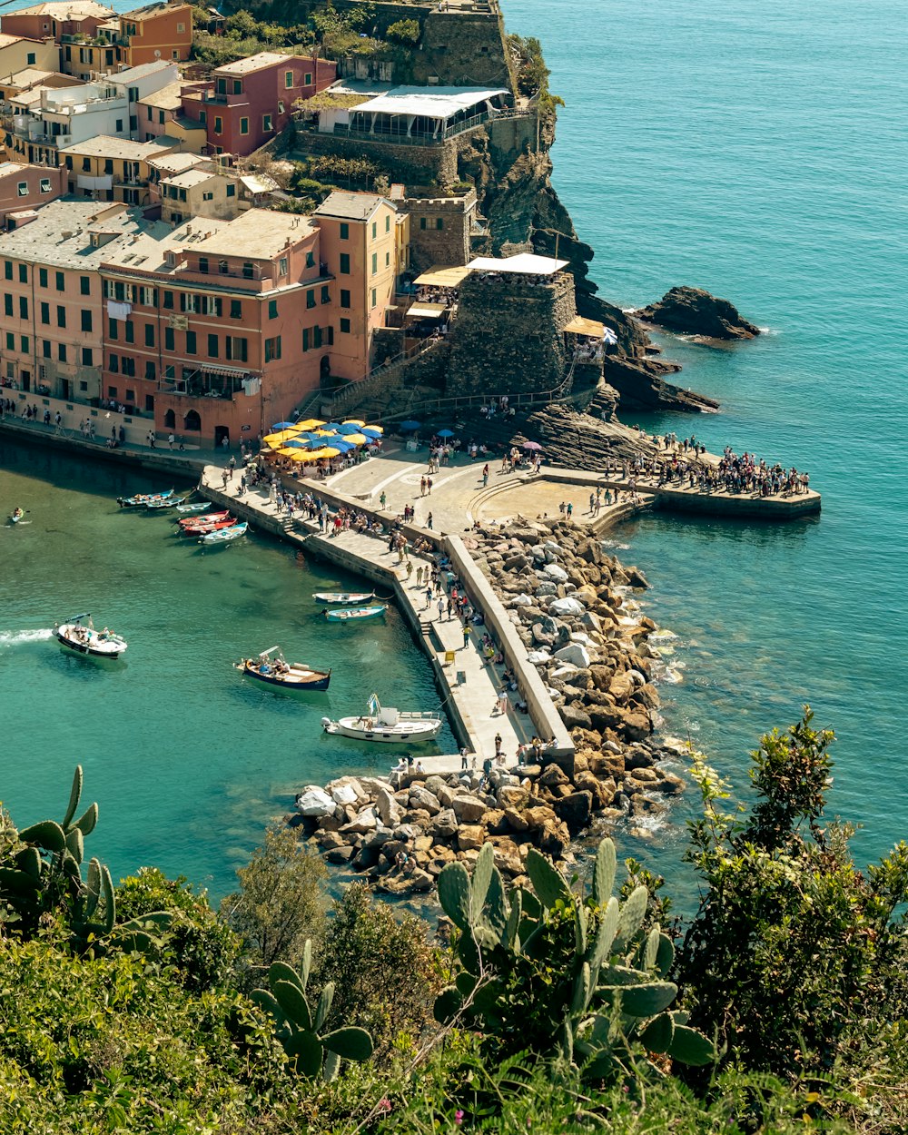 a harbor with boats in the water and a city in the background