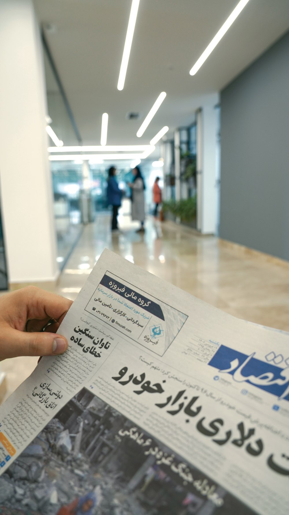 a person holding a newspaper in their hand