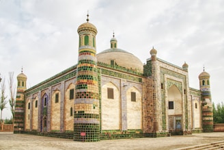 a large building with a green and white roof