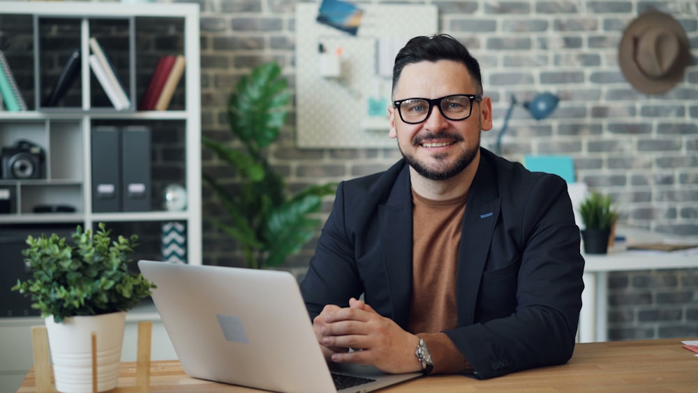 a man sitting at a table with a laptop