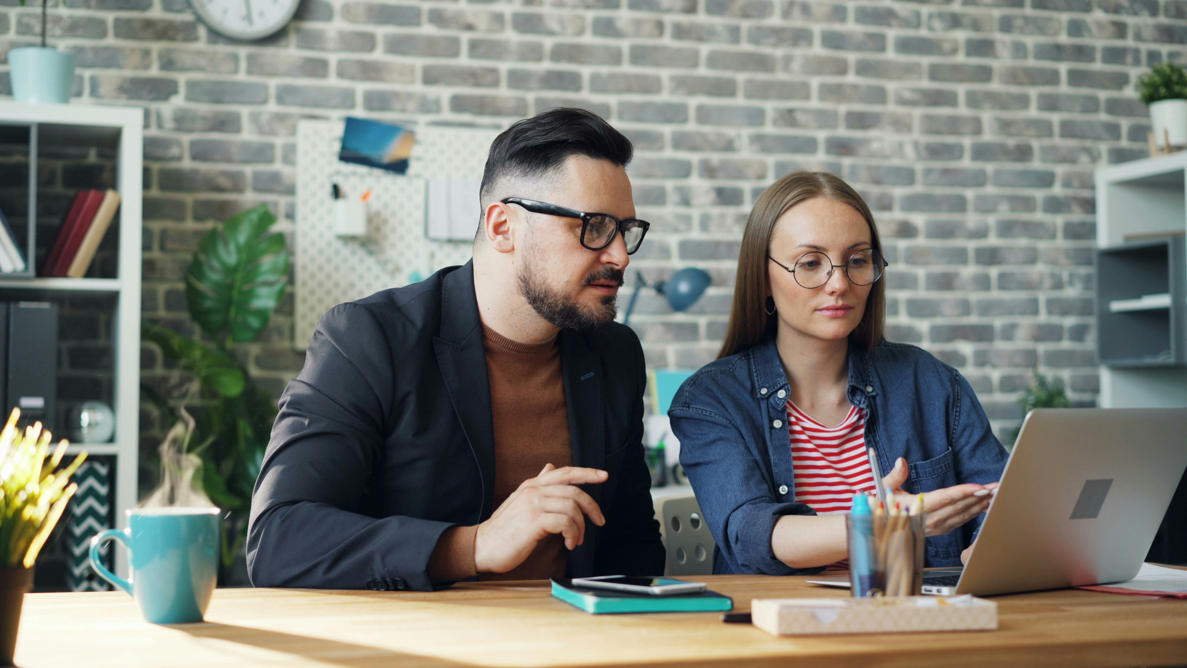 man and woman sitting on table