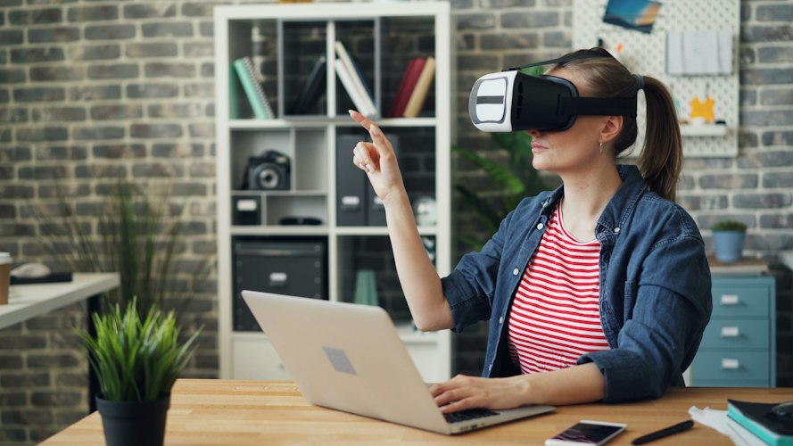 An open-plan office where employees test augmented reality headsets during a training session