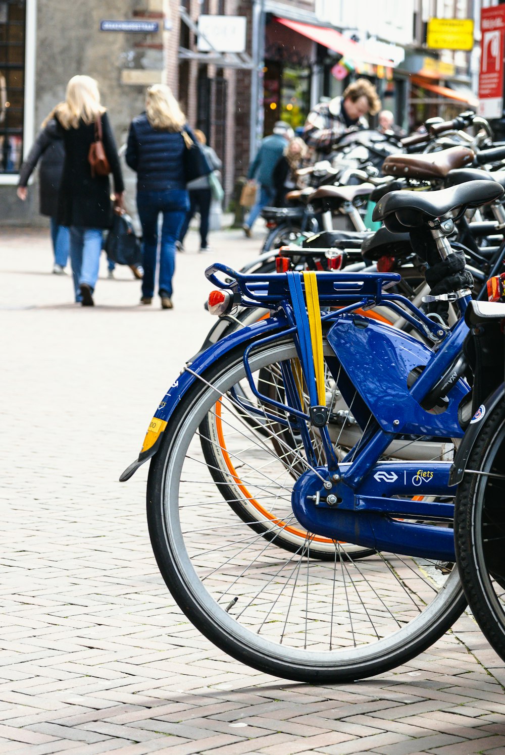 a row of bikes parked next to each other on a sidewalk