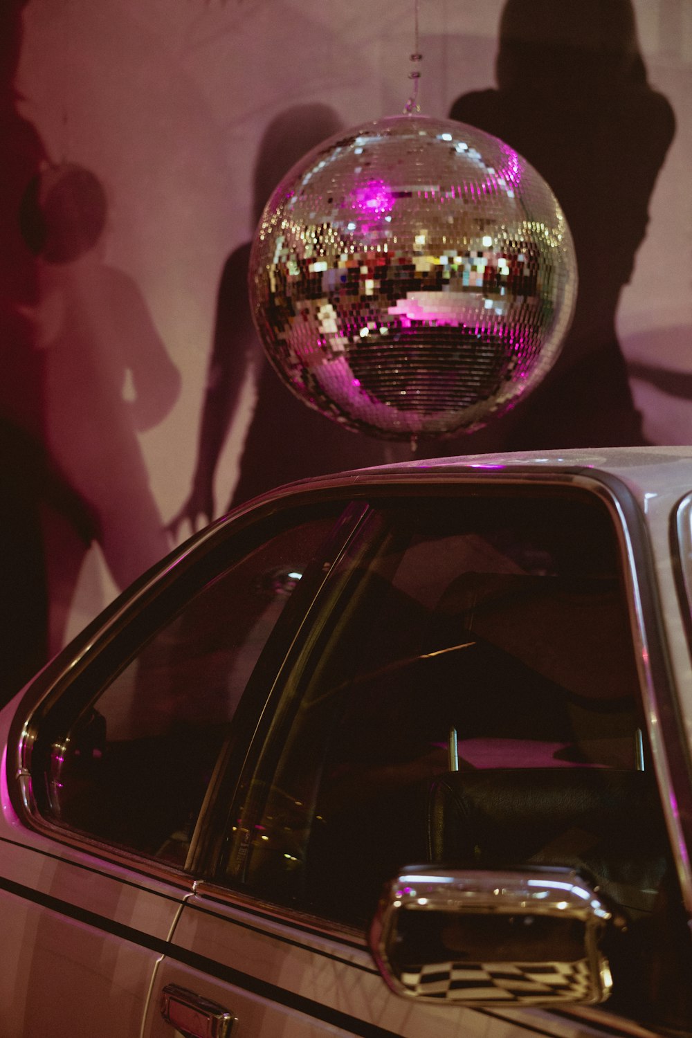 a disco ball sitting on top of a car