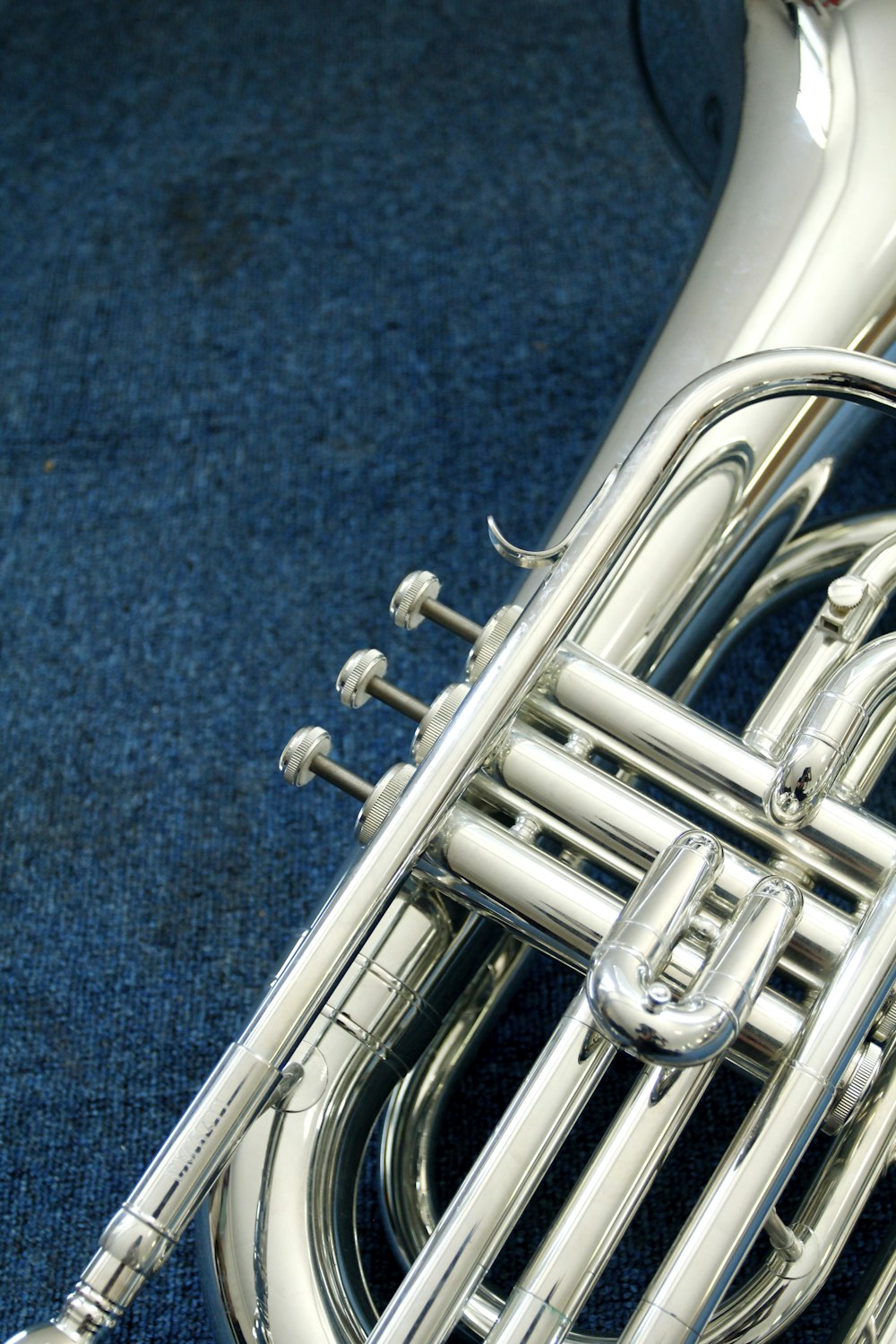 a close up of a trumpet on a blue carpet