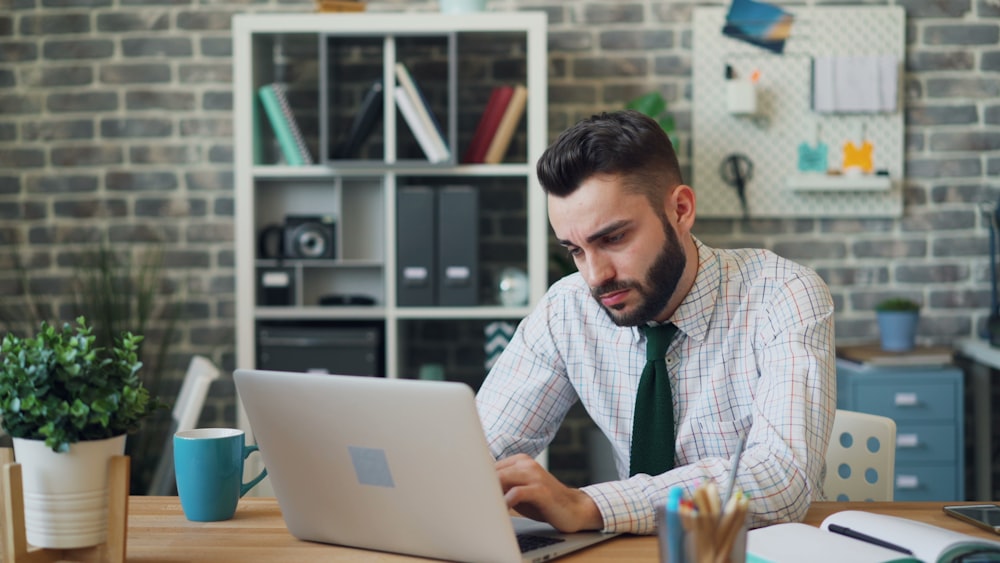 a man sitting in front of a laptop computer