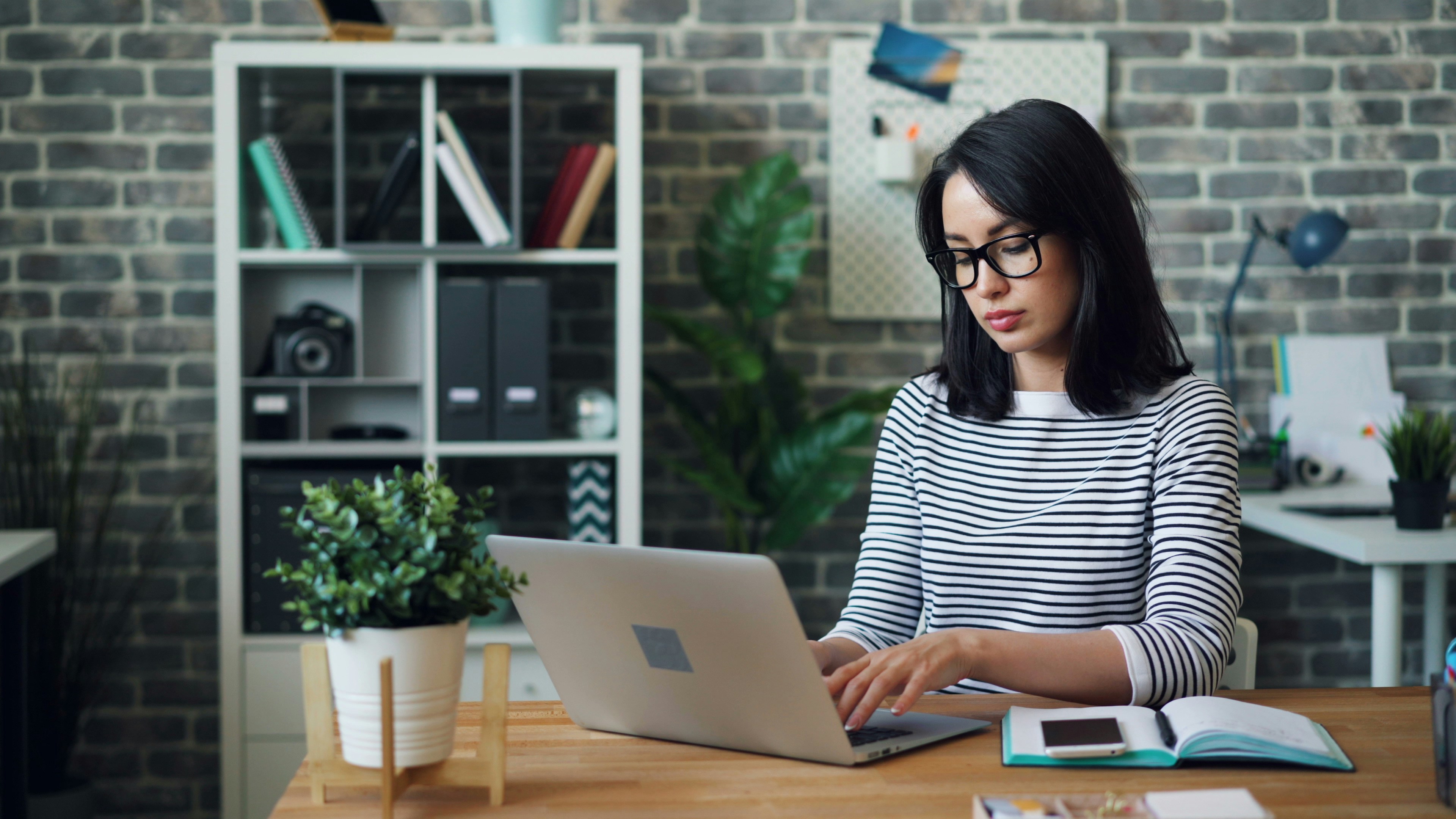 Tired woman working on laptop