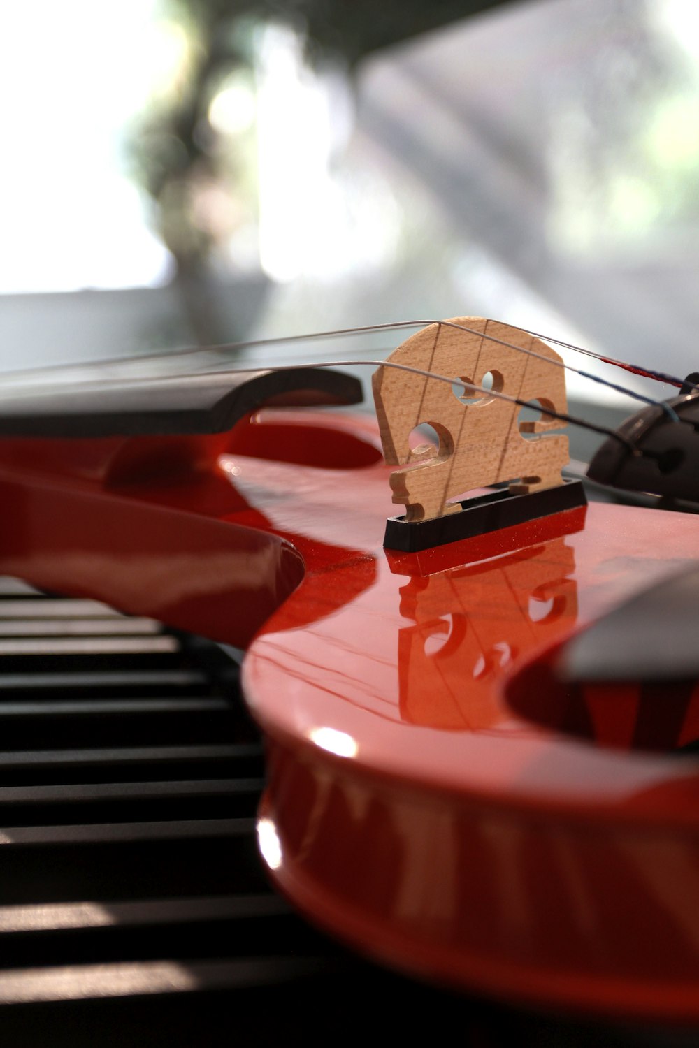 a red electric guitar with a piece of wood on top of it