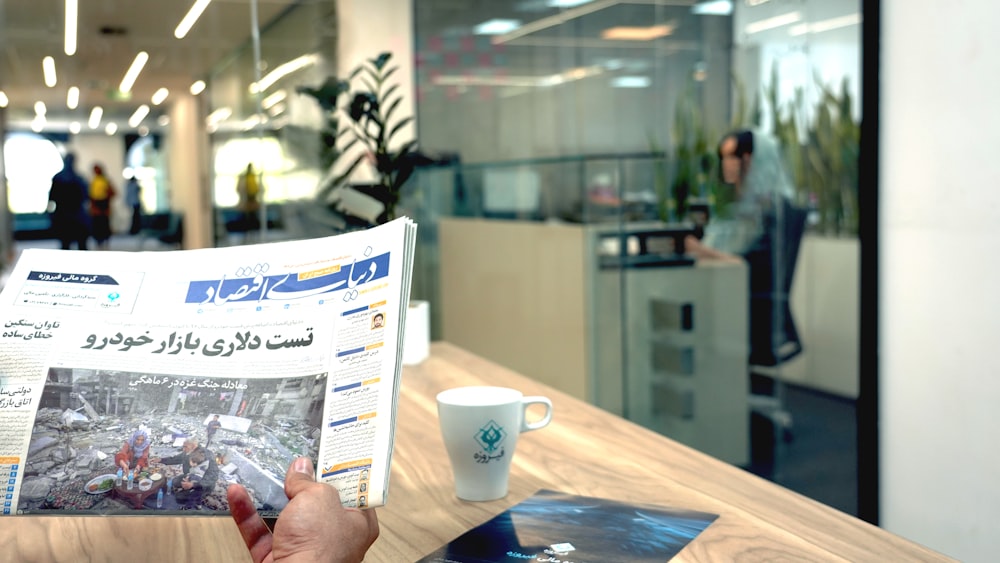 a person reading a newspaper in an office