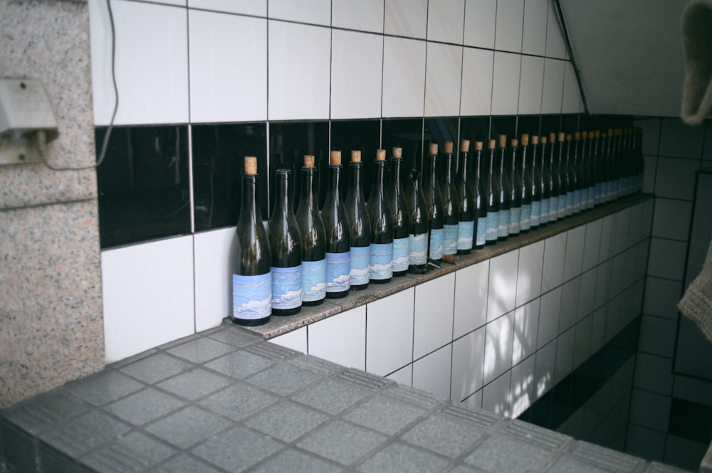 a row of bottles on a shelf in a bathroom