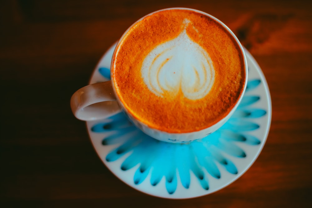 a cup of coffee on a saucer on a table