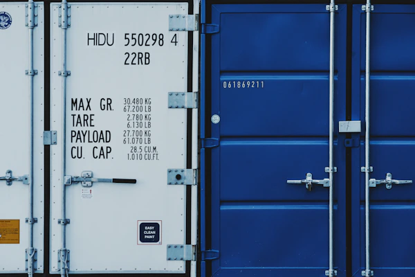a couple of blue and white shipping containers