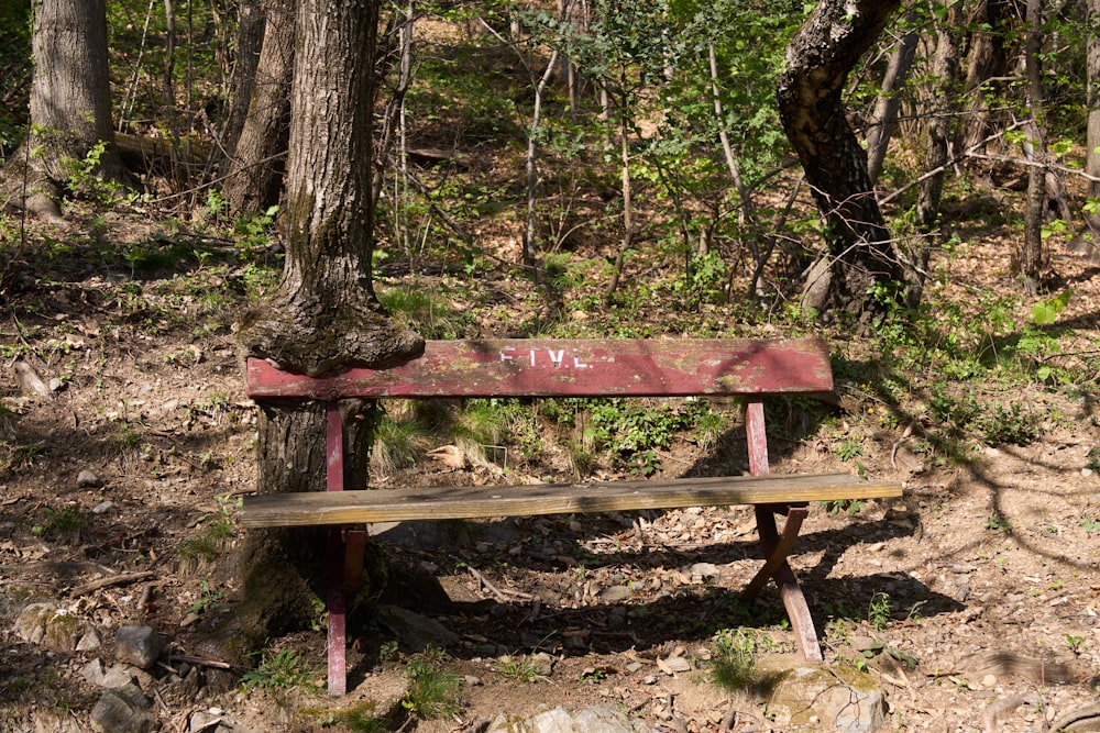 a wooden bench sitting in the middle of a forest