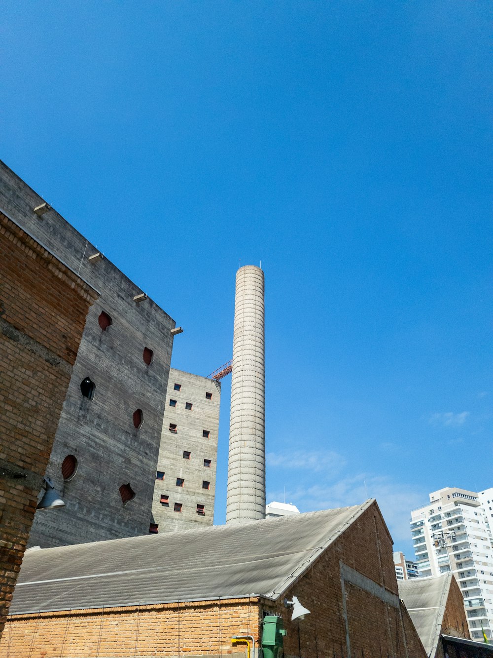 a brick building with a chimney in the background