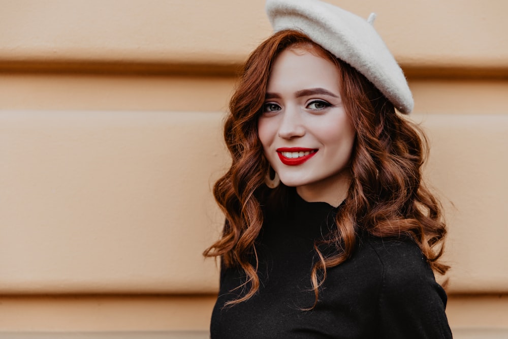 a woman with red lipstick and a white hat