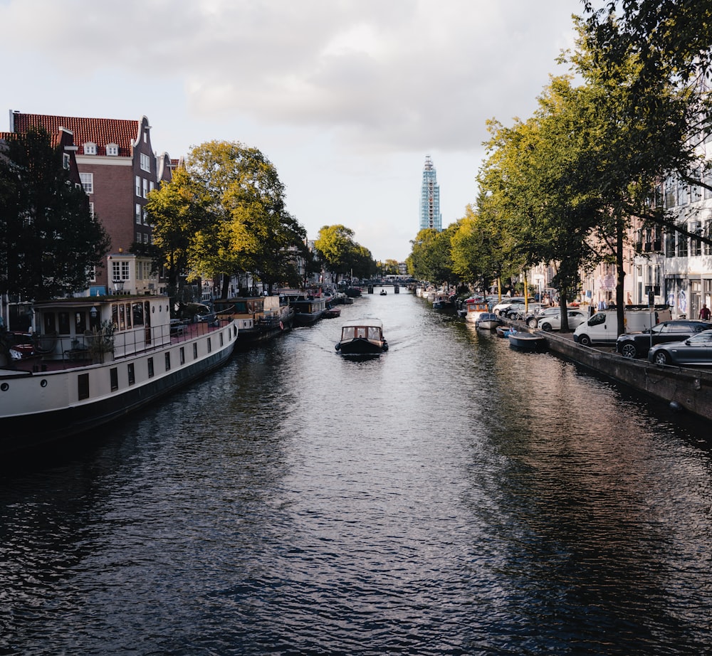 a river with boats on it and buildings on both sides