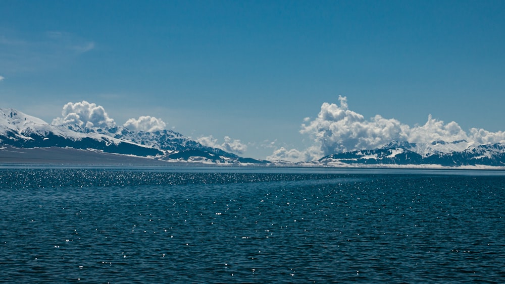 a large body of water with mountains in the background