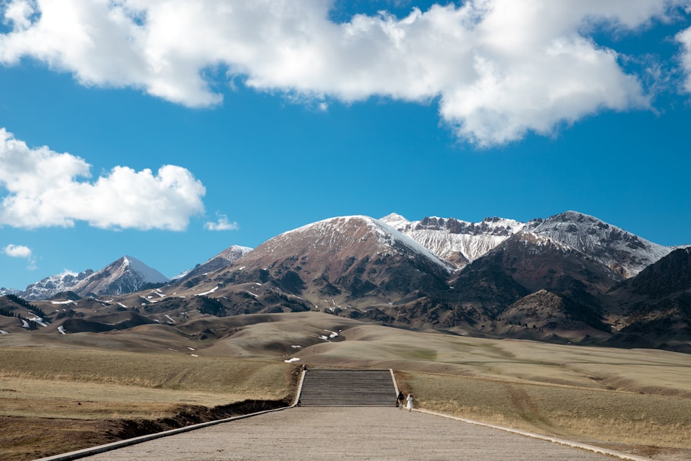 a scenic view of mountains and a road