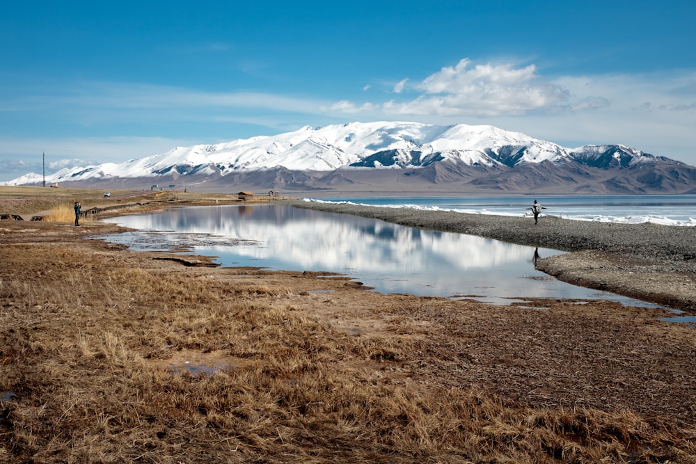 a body of water with a mountain in the background