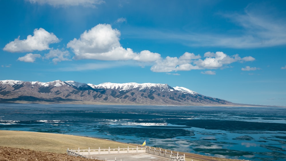 a large body of water with mountains in the background