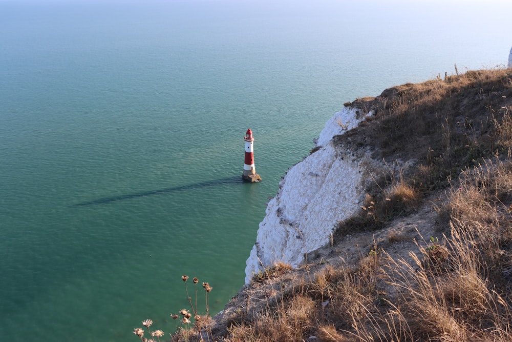 a light house sitting on top of a cliff next to the ocean