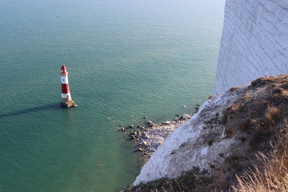 a light house in the middle of a body of water