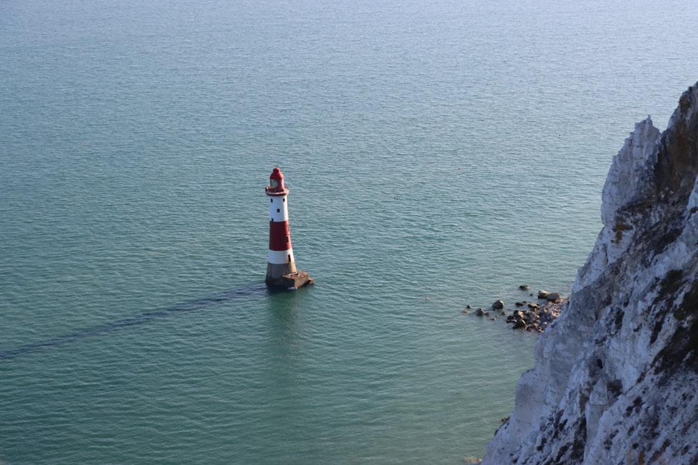 a lighthouse in the middle of a body of water