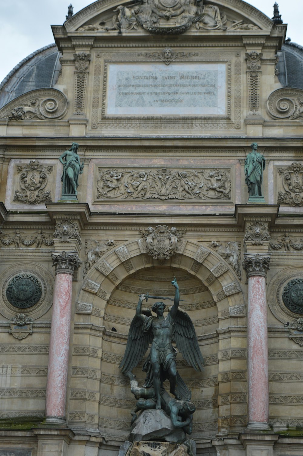 a large building with a statue on top of it