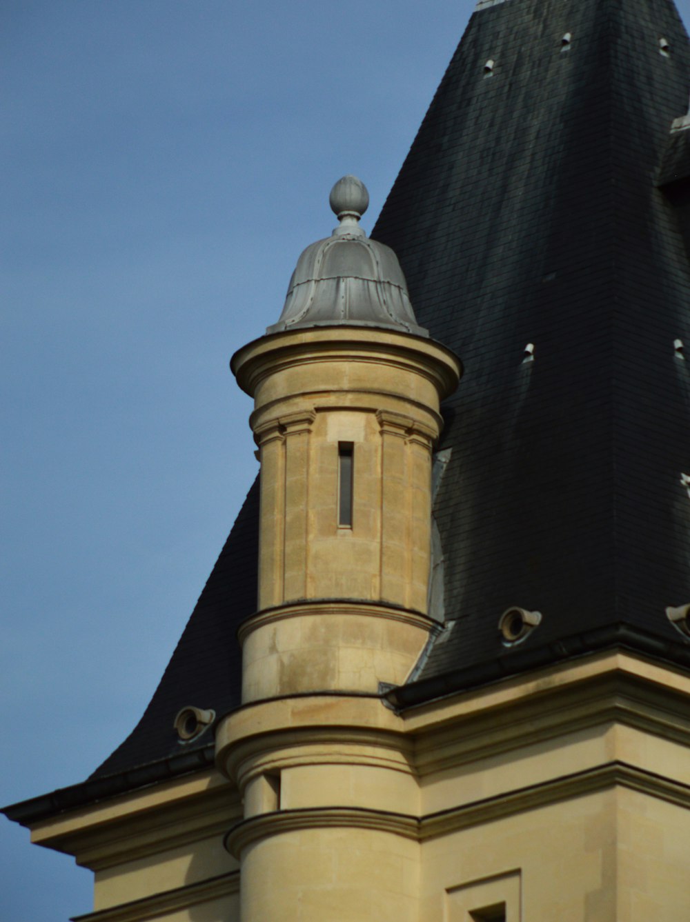 a clock on a tower with a sky background