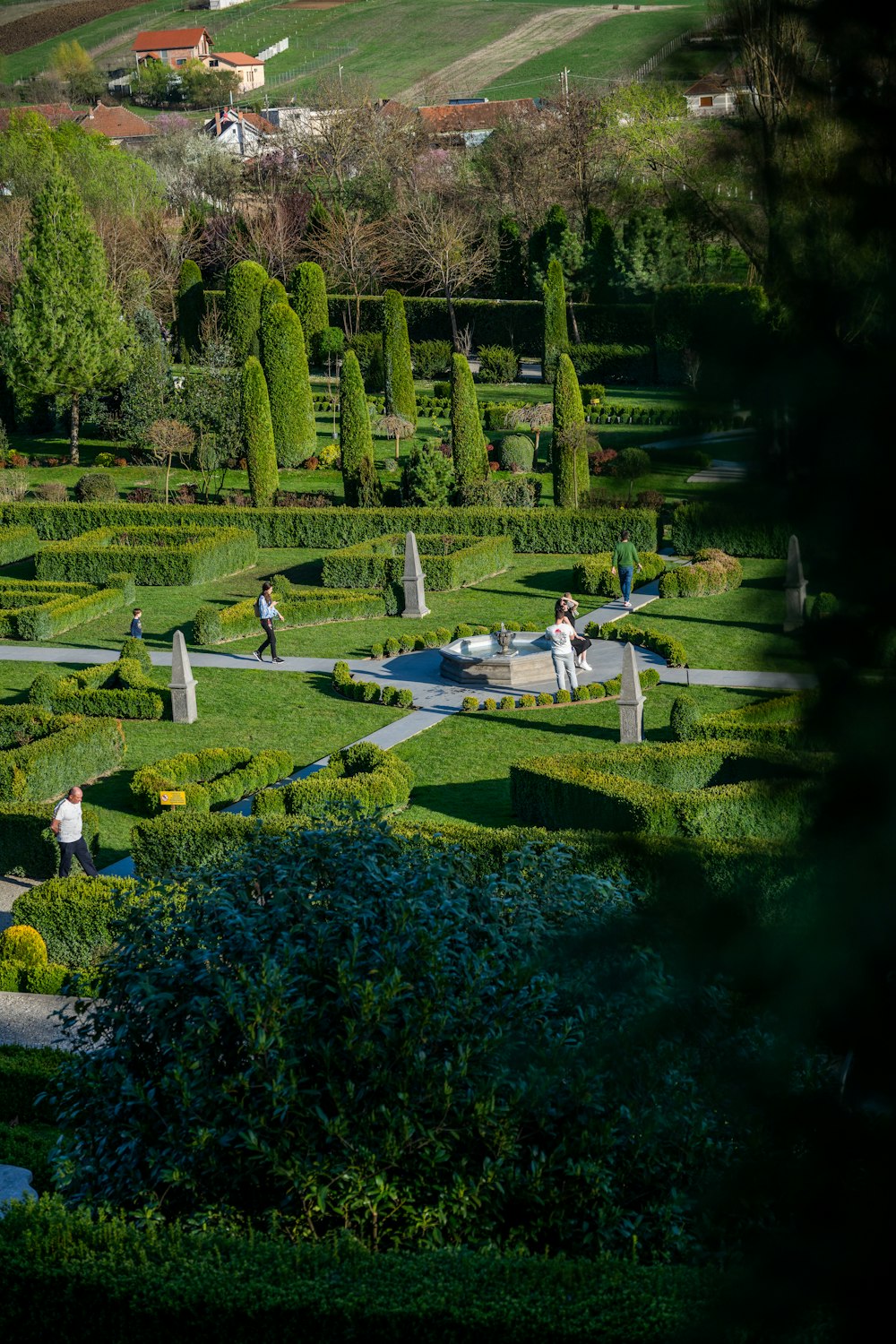 a group of people standing around a garden