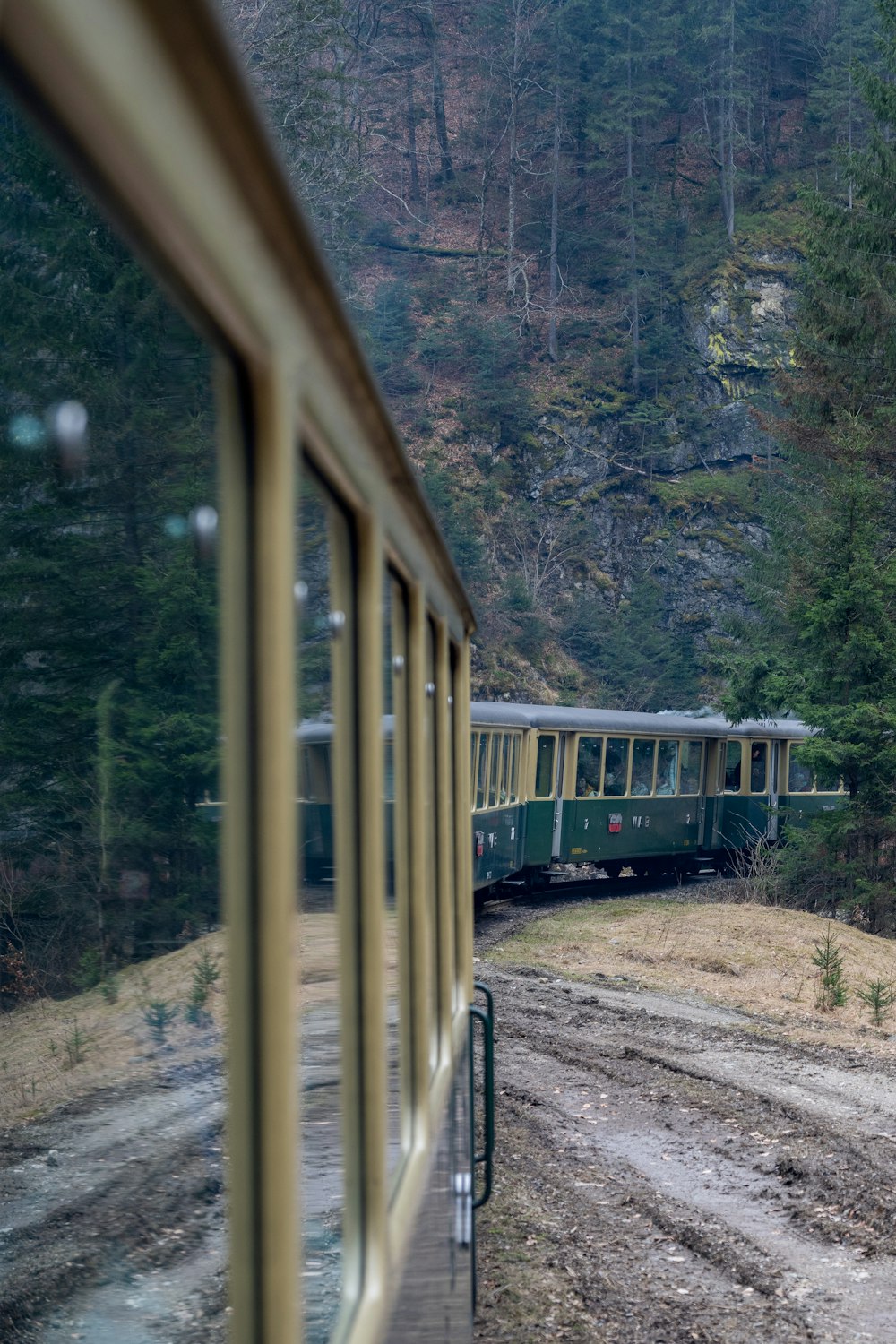 a train traveling down tracks next to a forest