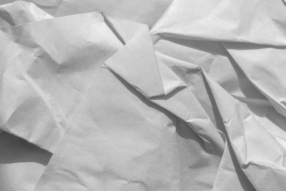 a black and white photo of crumpled paper