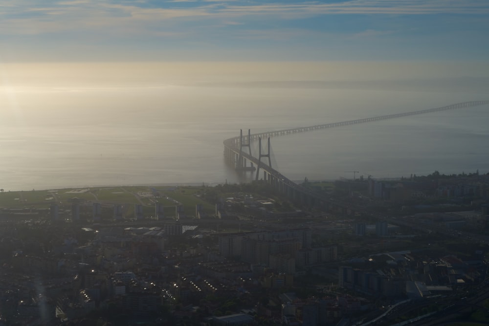 an aerial view of a bridge in the fog